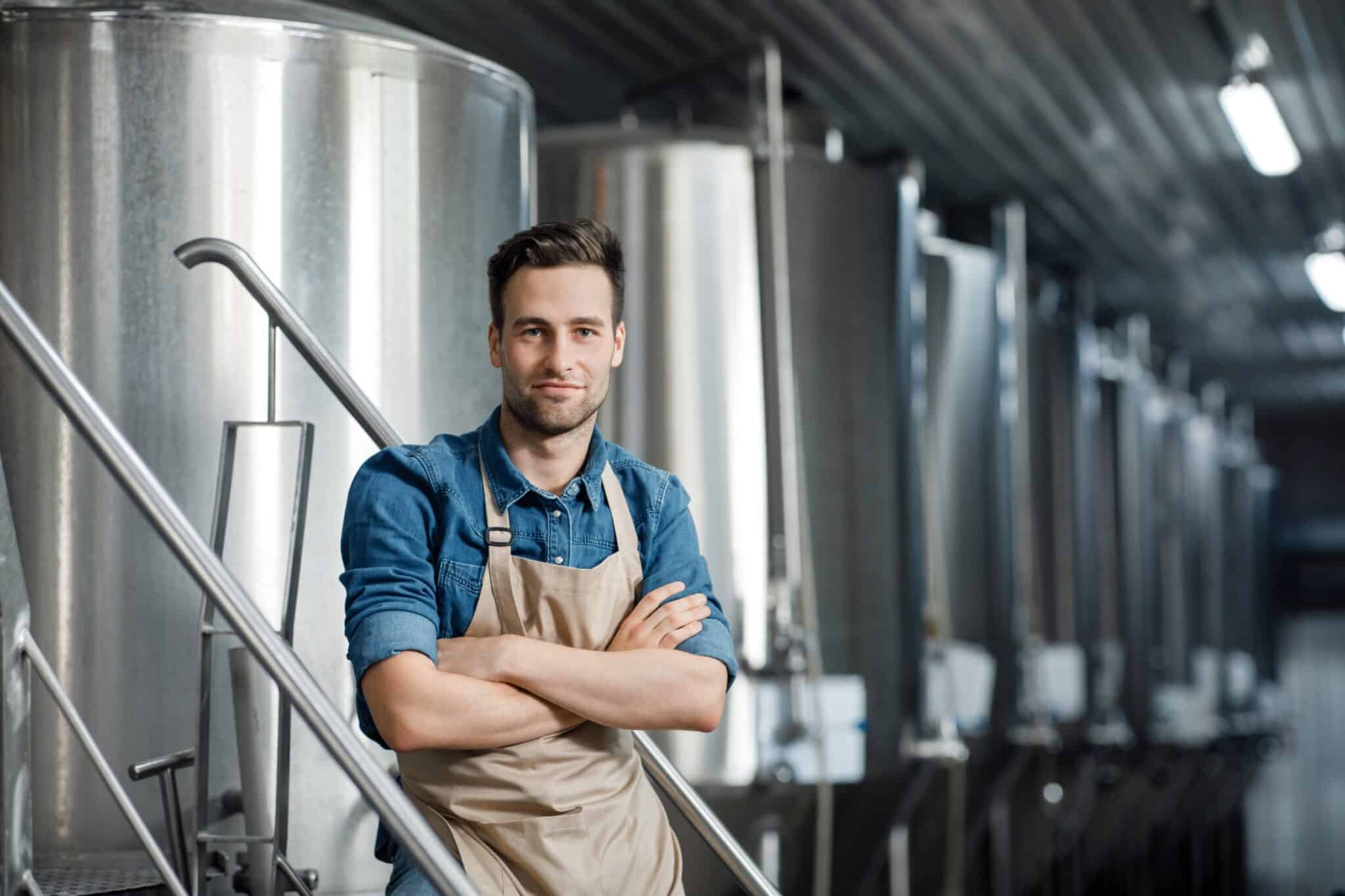 a man standing in front of a brewery