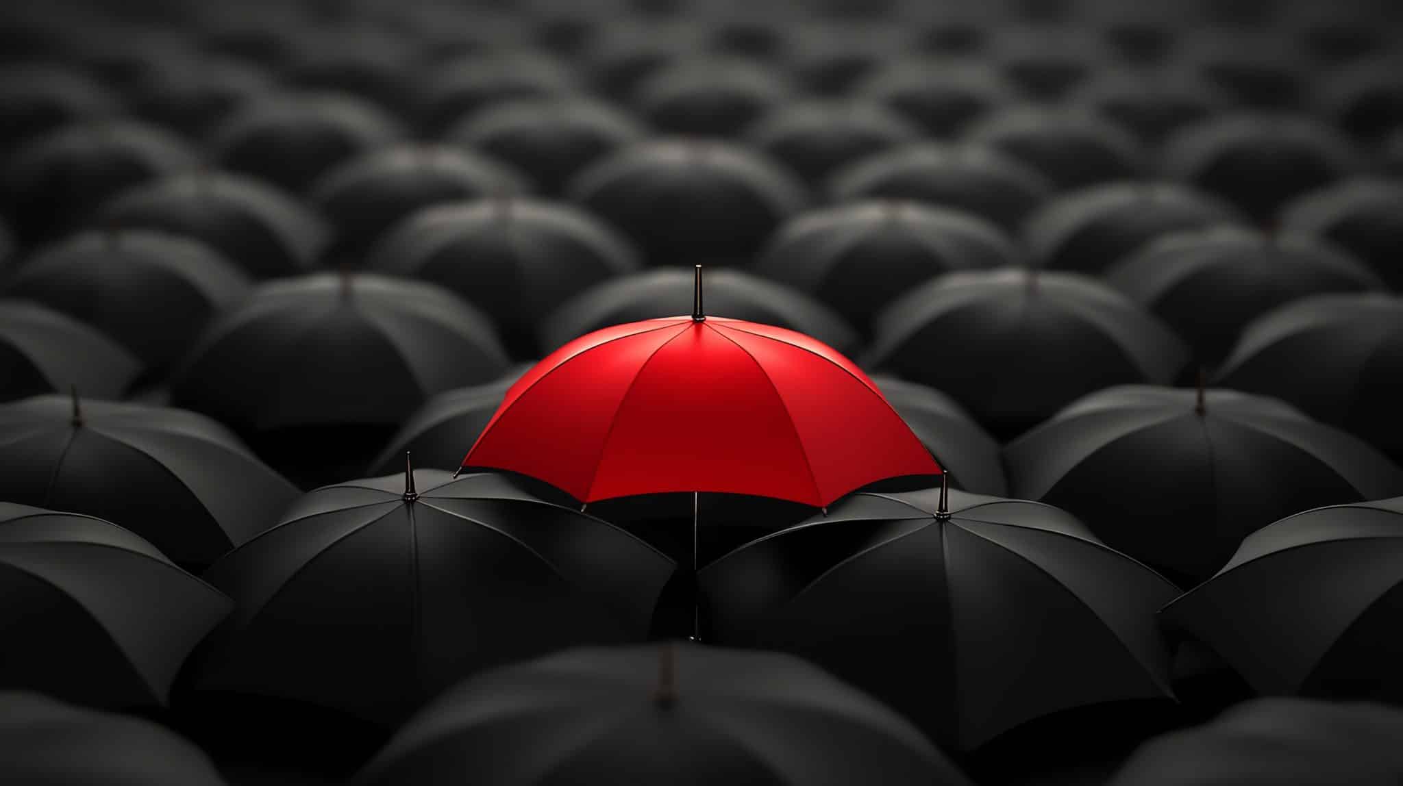 A single red umbrella stands out among a sea of closed black umbrellas, reminiscent of a standout idea on a website. The image, captured from above, mirrors how unique services can shine through, creating striking visual interest against a dark background.