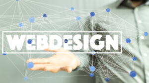A person in a gray shirt reaching out with their hand, touching a network of interconnected blue dots, with the word "WEBDESIGN" in bold white letters overlaying the image.