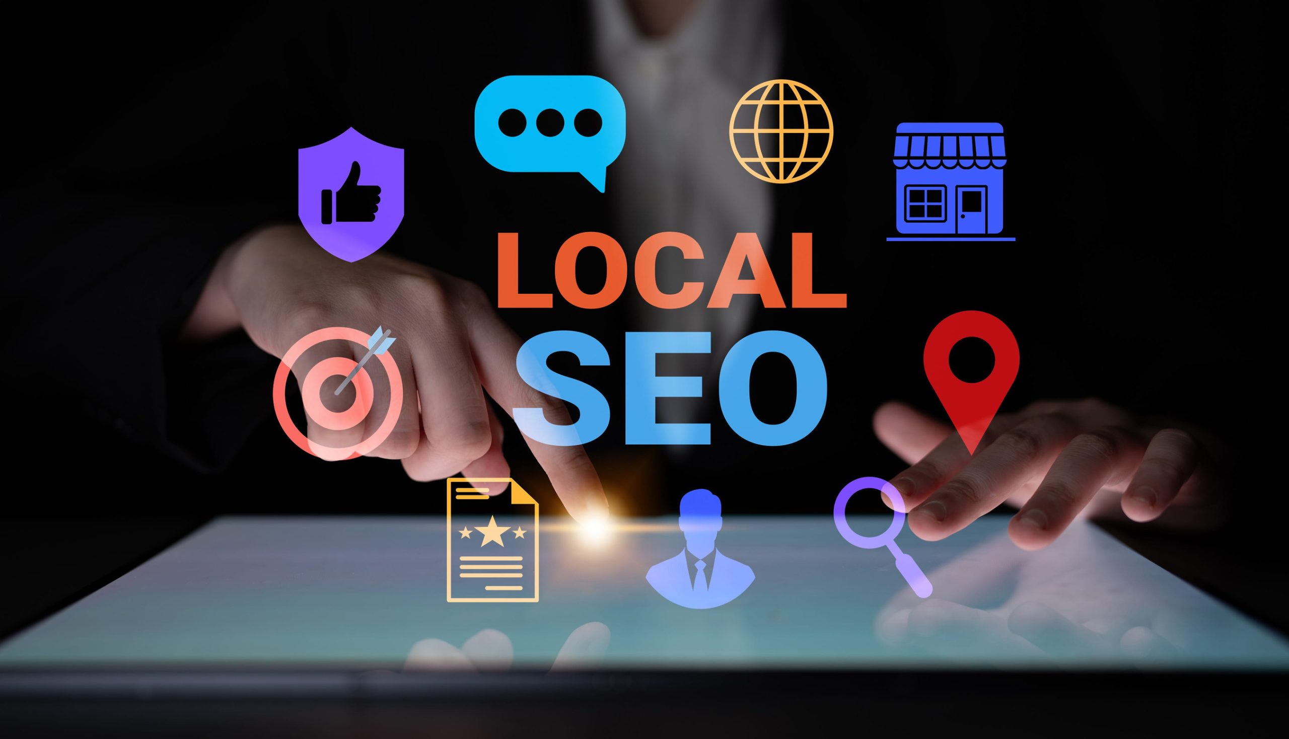 A person uses a touchscreen with colorful icons and the text “LOCAL SEO” at the center, highlighting local search rankings and optimization concepts.
